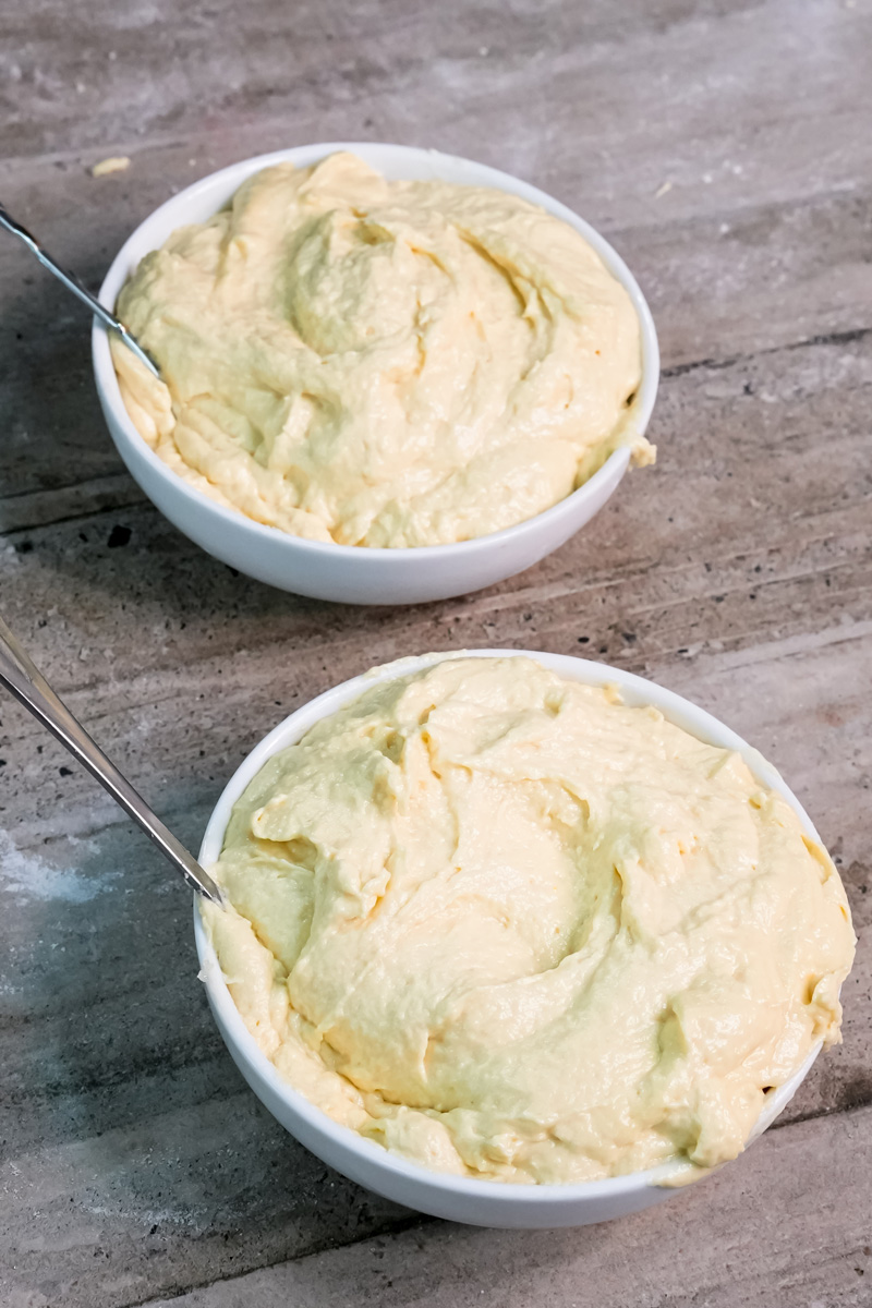 Plain Battenberg cake batter in bowls before adding food coloring