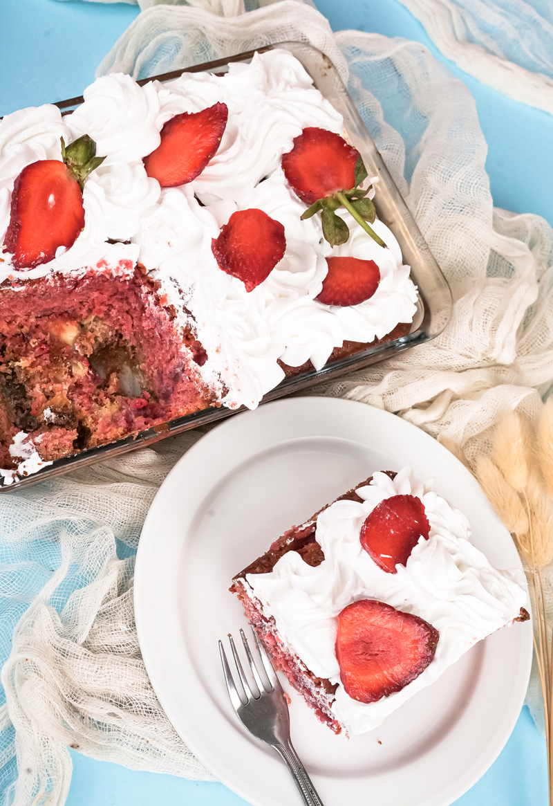 Cut strawberry earthquake cake revealing colorful interior texture
