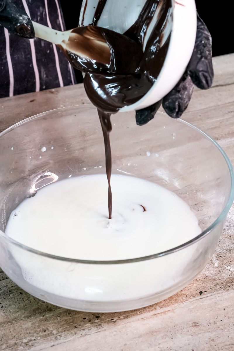 Pouring melted Nutella into milk for pancake batter