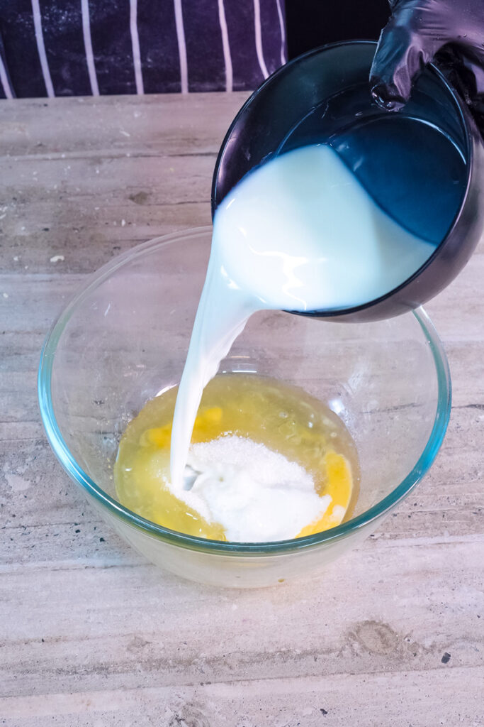 Pouring milk into pancake roll batter ingredients