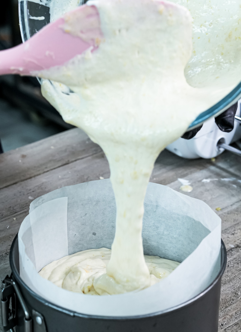Pouring vanilla sponge batter into lined cake pan for Fraisier cake