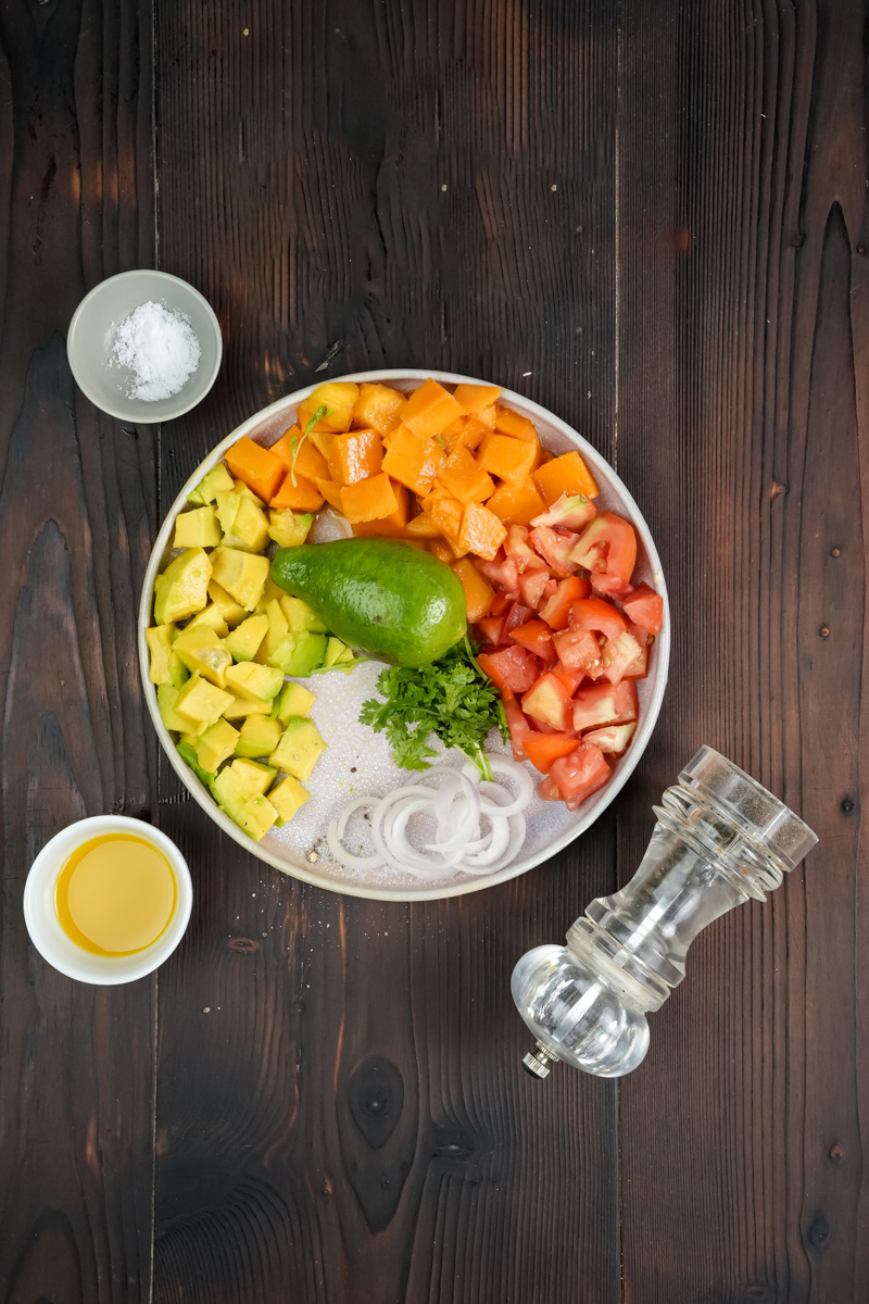 Prepped mango avocado salad ingredients in bowl ready to mix
