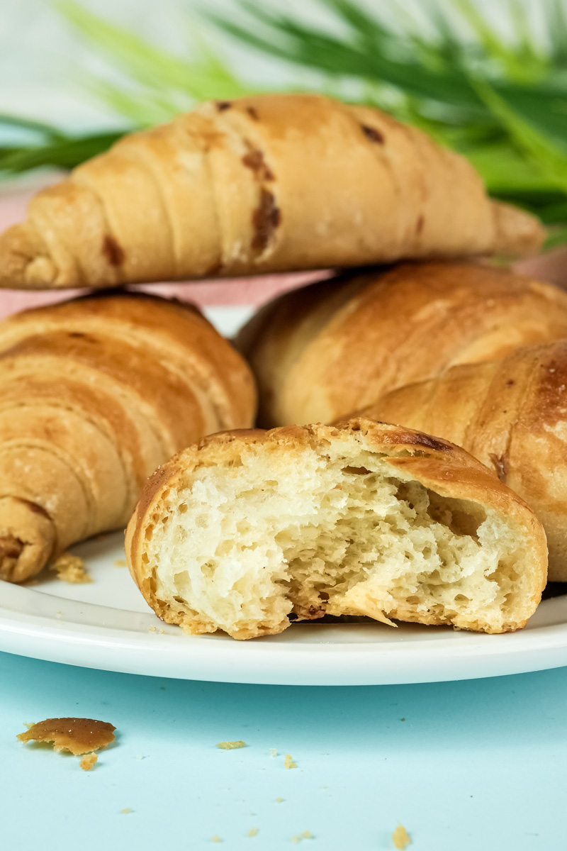 Raisin croissant cut open showing flaky pastry layers
