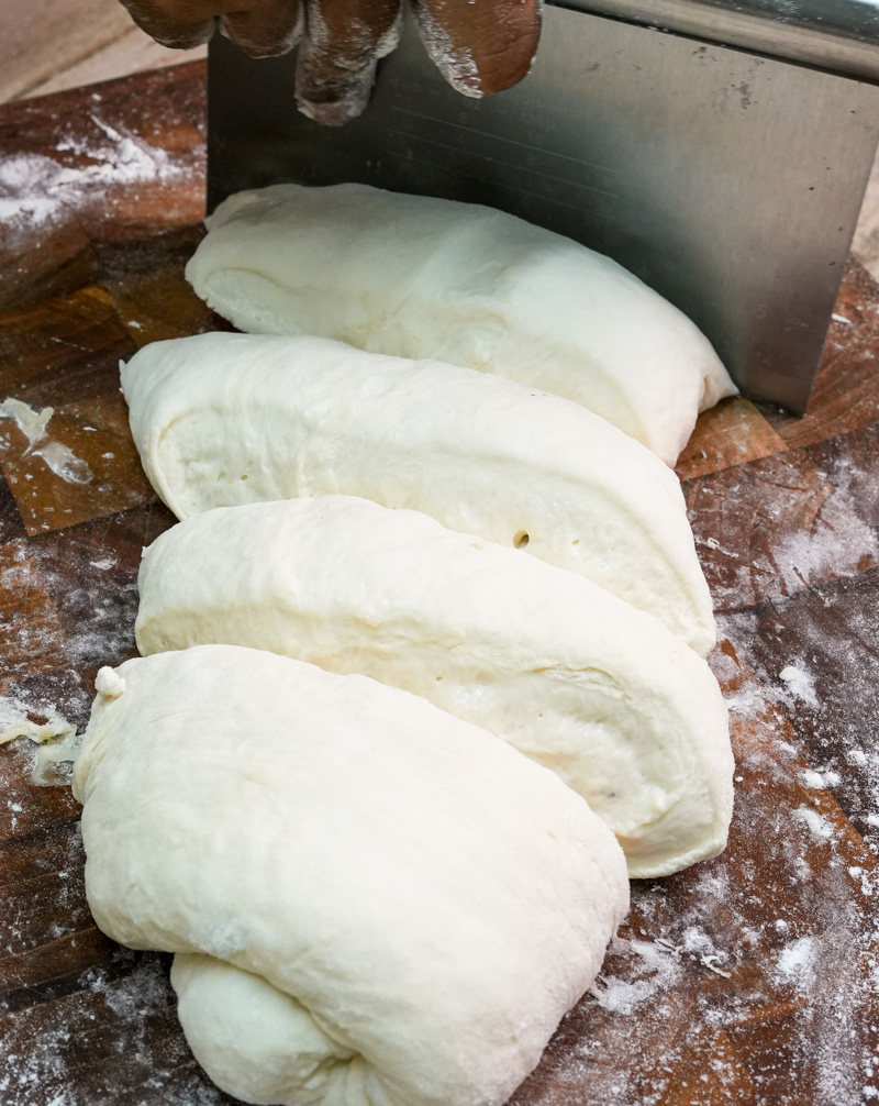 Raw ciabatta dough portions shaped and ready for baking
