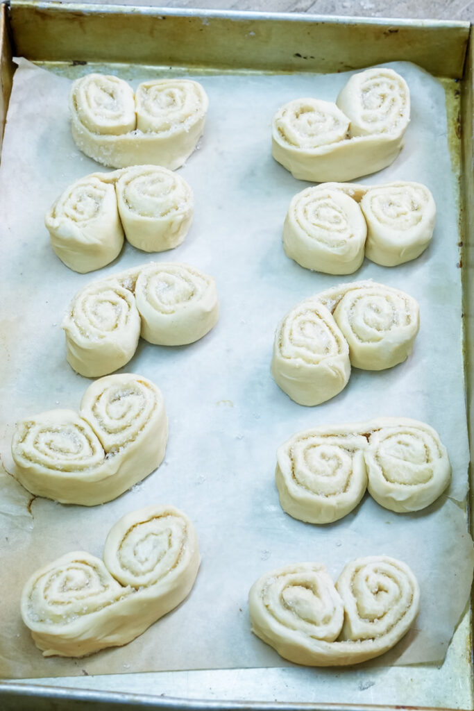 Raw palmiers positioned on baking sheet before cooking