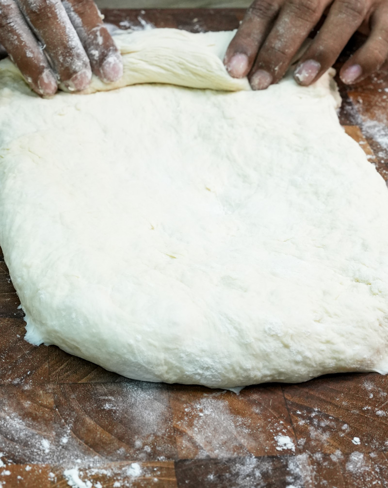 Rolling ciabatta bread dough by hand