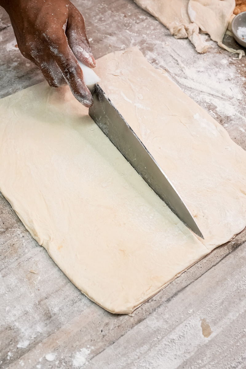 Rolling out puff pastry dough for apple turnovers