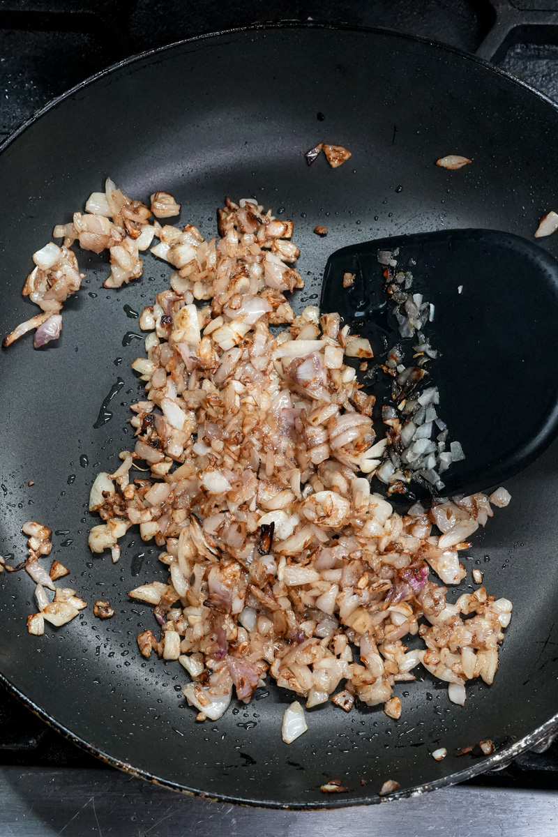 Sautéing diced onions for chicken empanada filling