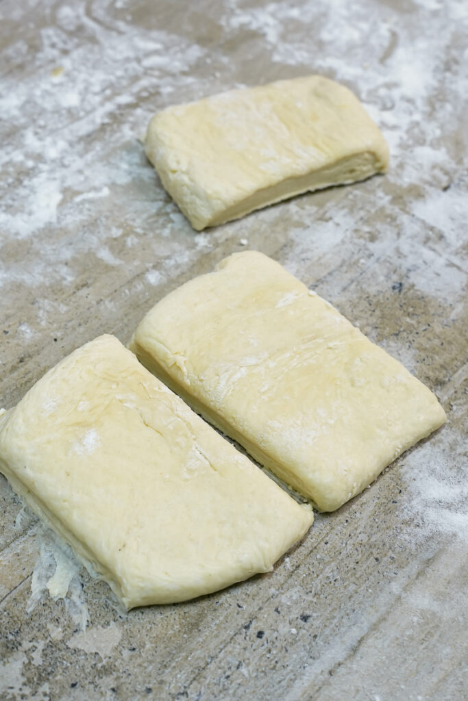 Shaped Danish pastry dough pieces ready for topping