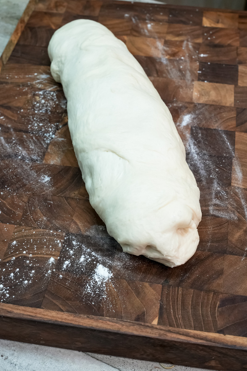 haped bun dough on wooden cutting board