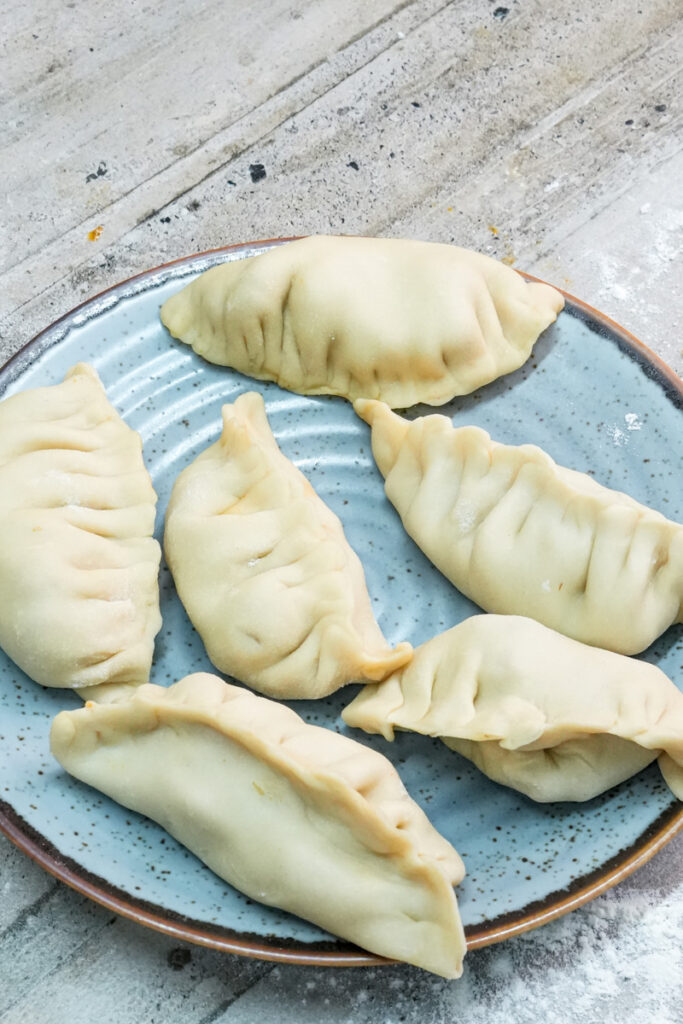 Shaped chicken empanada before baking process