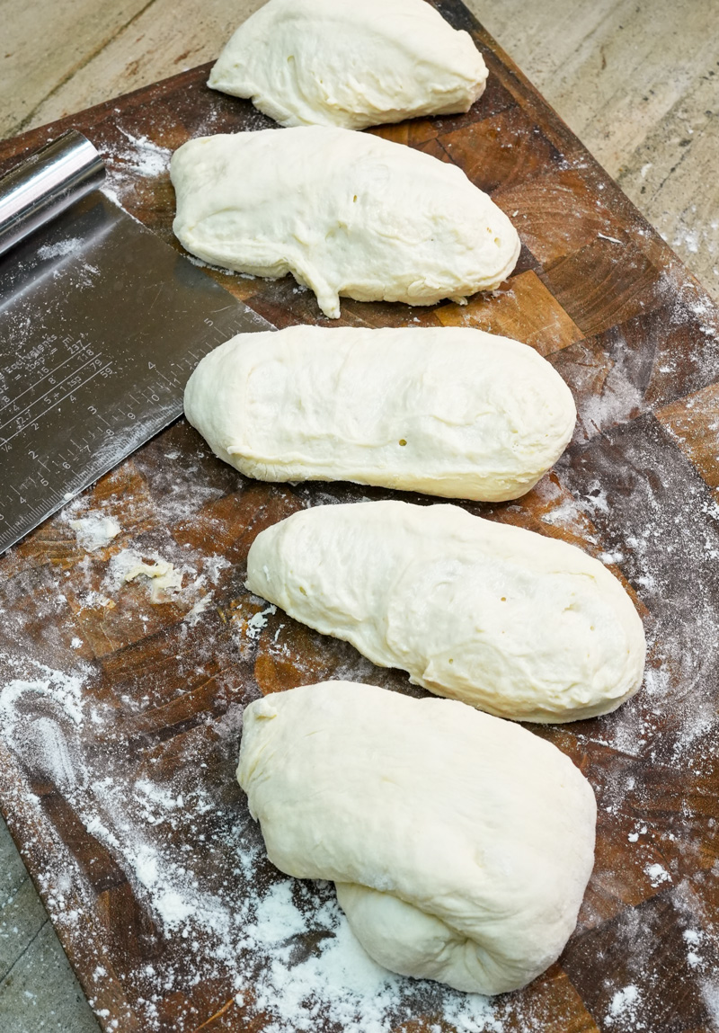 Shaped ciabatta bread loaves on cutting board