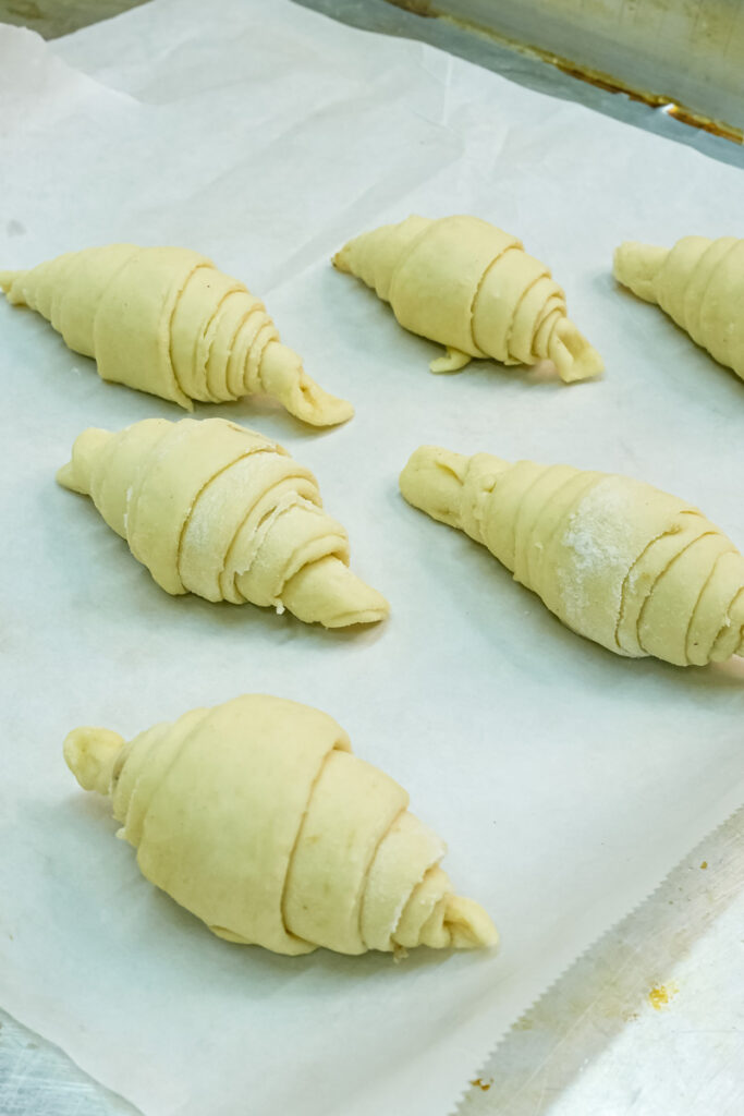 Shaped croissants on baking sheet before baking