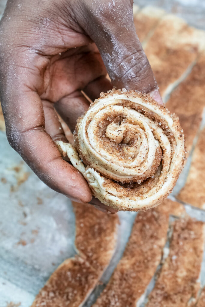 Shaped cruffin dough placed in buttered muffin tin