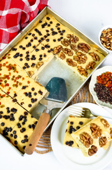 Plated sheet pan pancake slice with walnut and berry toppings