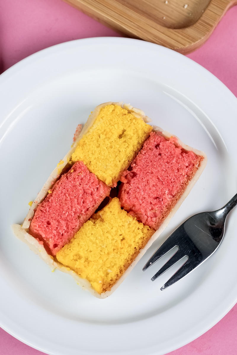 Battenberg cake slice plated for serving with checkered pattern visible