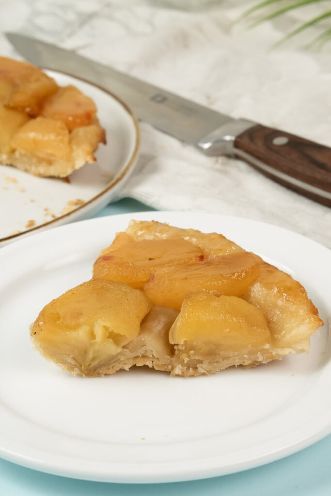 Slice of Tarte Tatin showing flaky pastry and caramelized apples
