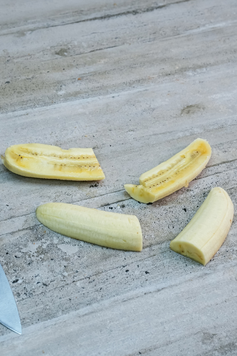 Sliced bananas on marble surface for lumpia preparation