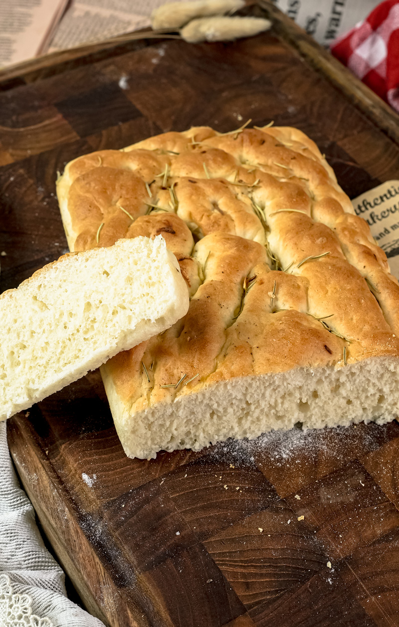 Sliced focaccia bread on wooden cutting board