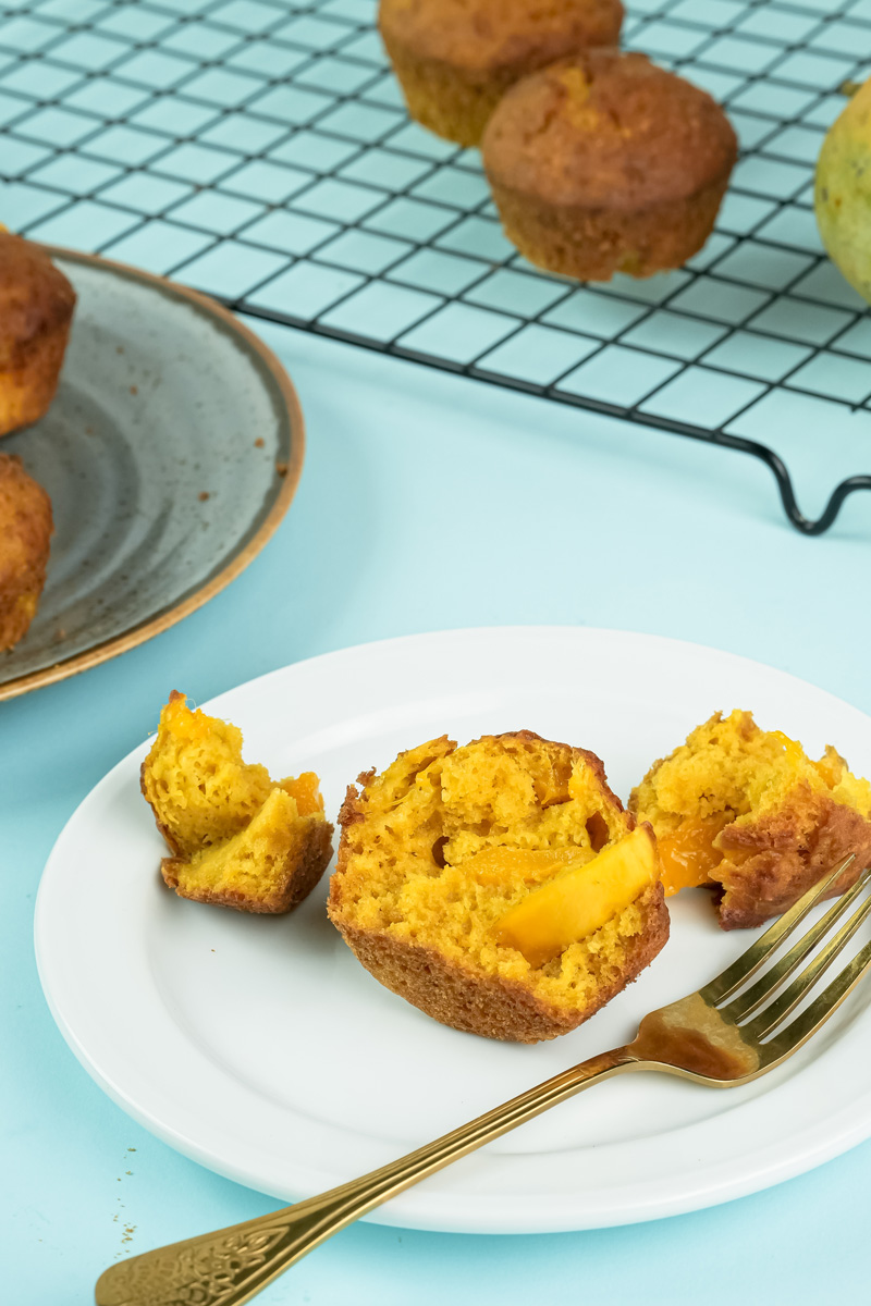 Sliced mango muffin showing moist interior with fresh mango pieces