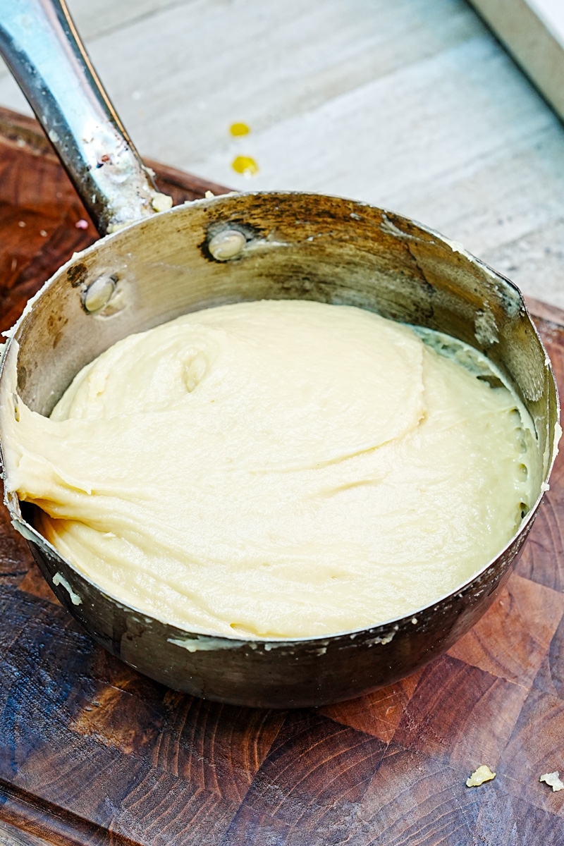 Smooth choux pastry dough in saucepan ready for piping