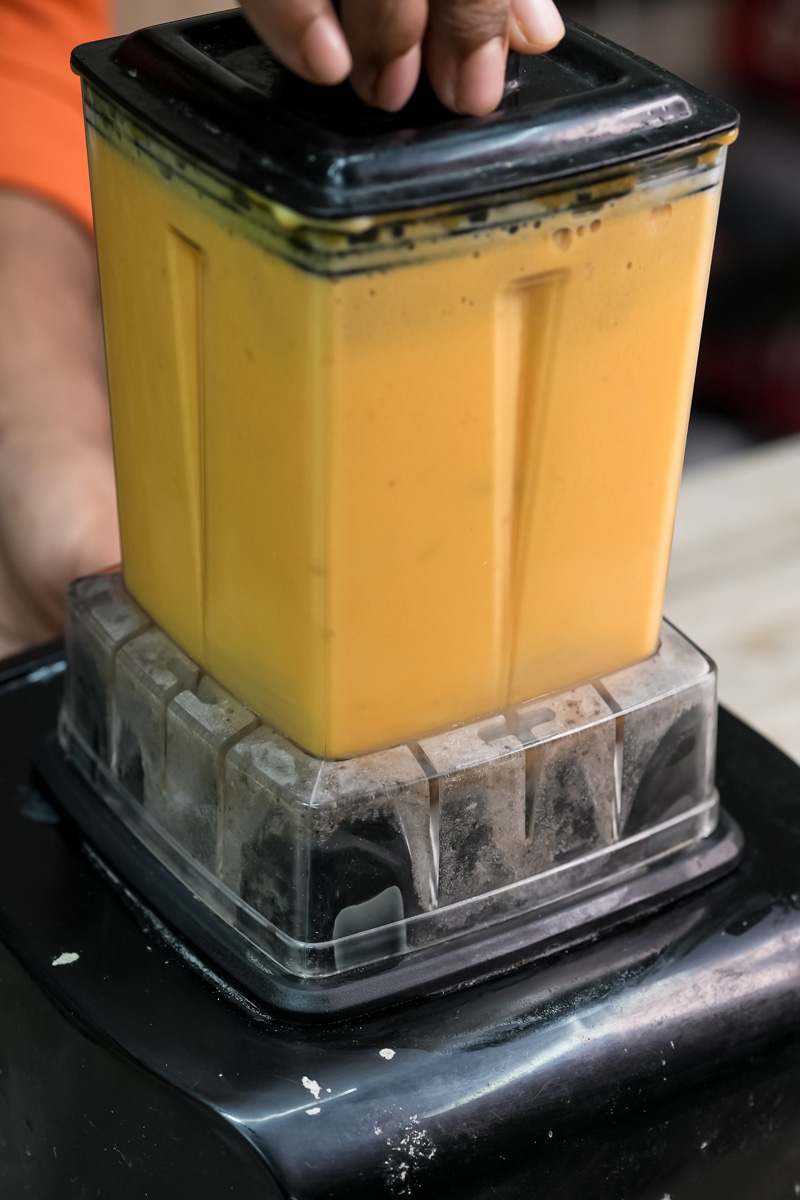 Smooth mango puree in blender container
