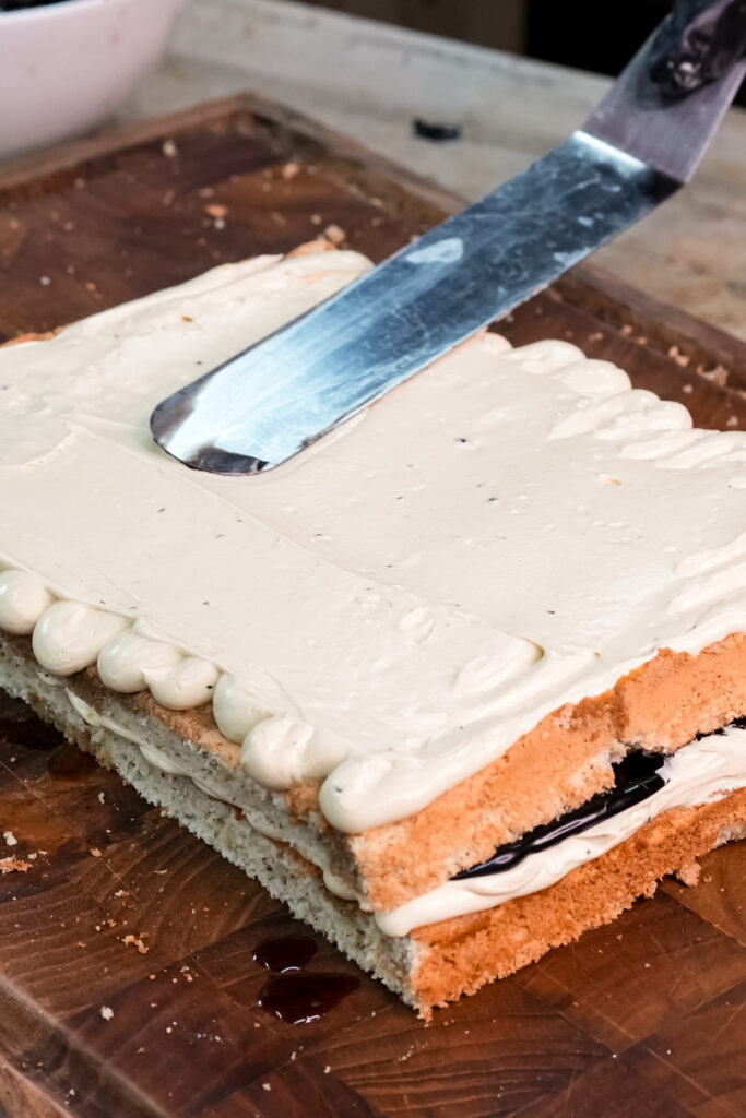Smoothing buttercream layer on opera cake with knife technique