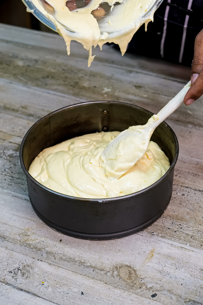 Smoothing citrus cake batter with spatula before baking