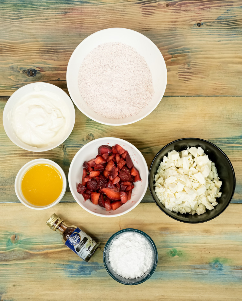 Strawberry earthquake cake ingredients laid out on wooden surface