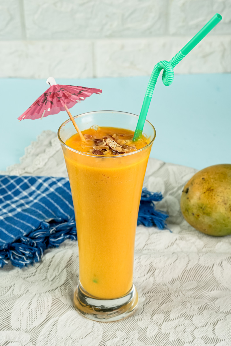 Summer mango milkshake with tropical decorations