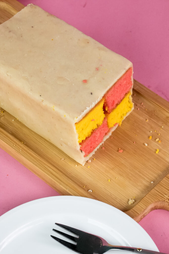Traditional British Battenberg cake ready to serve on wooden board