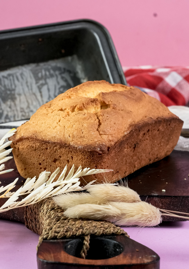Traditional Madeira cake on wooden cutting board with wheat decoration