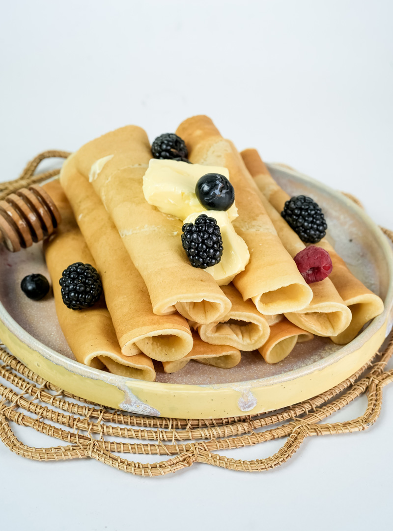 Traditional pancake rolls with blackberries, blueberries and raspberry
