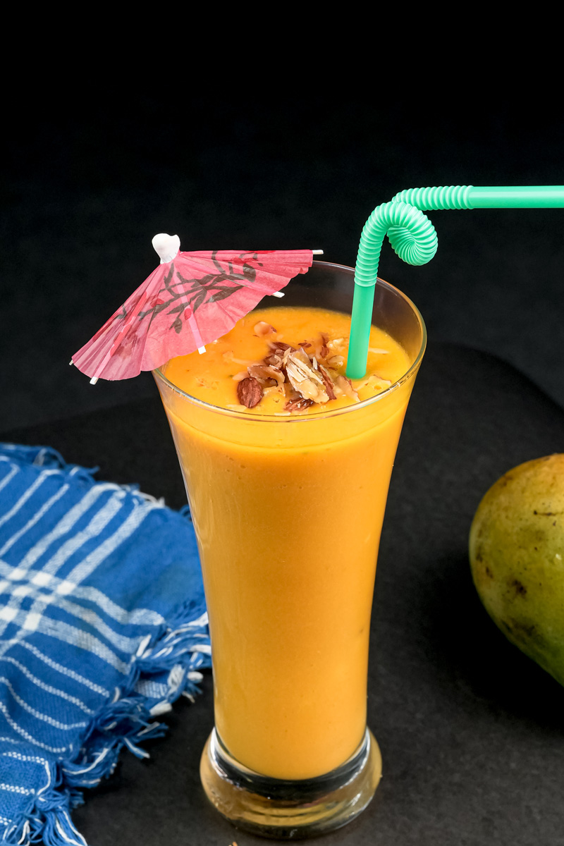 Tropical mango milkshake with cocktail umbrella decoration