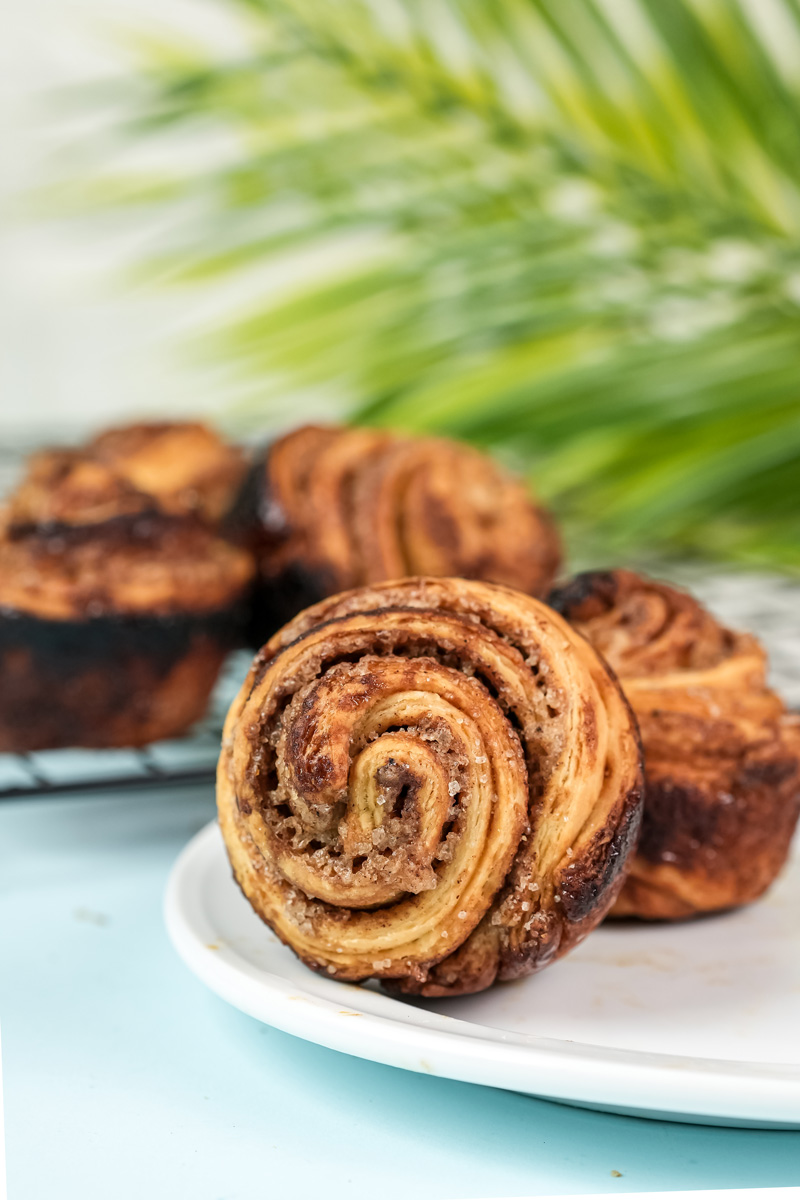 Two cruffins on white plate with blurred background