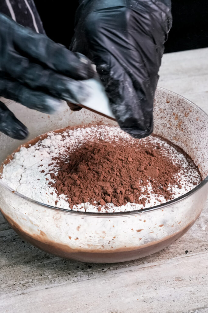 Whisking flour into chocolate pancake batter