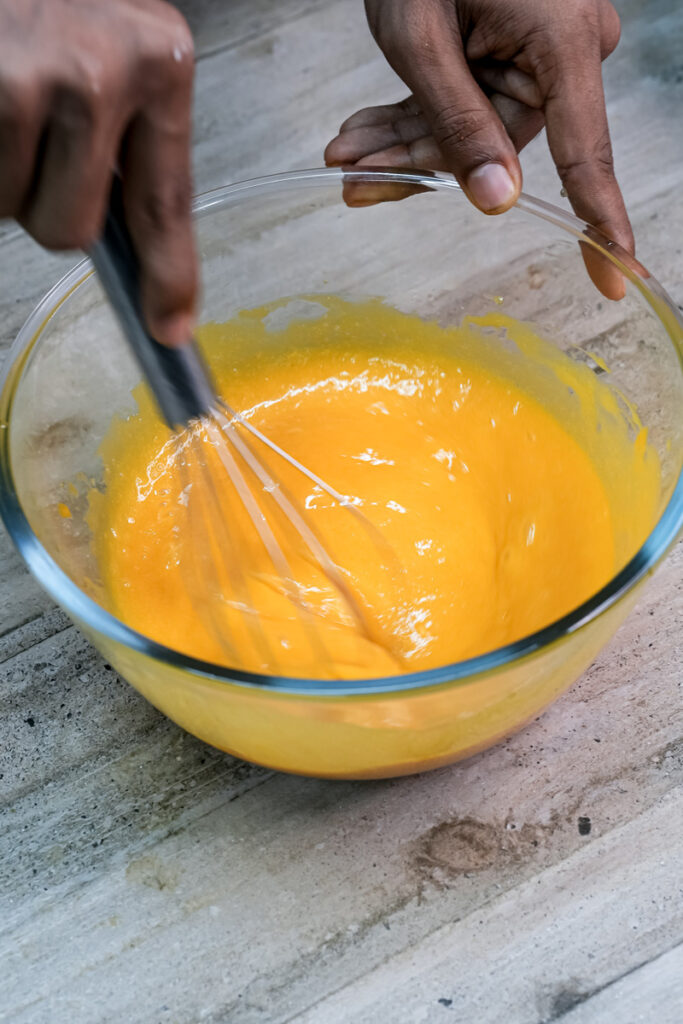 Whisking mango muffin wet ingredients together