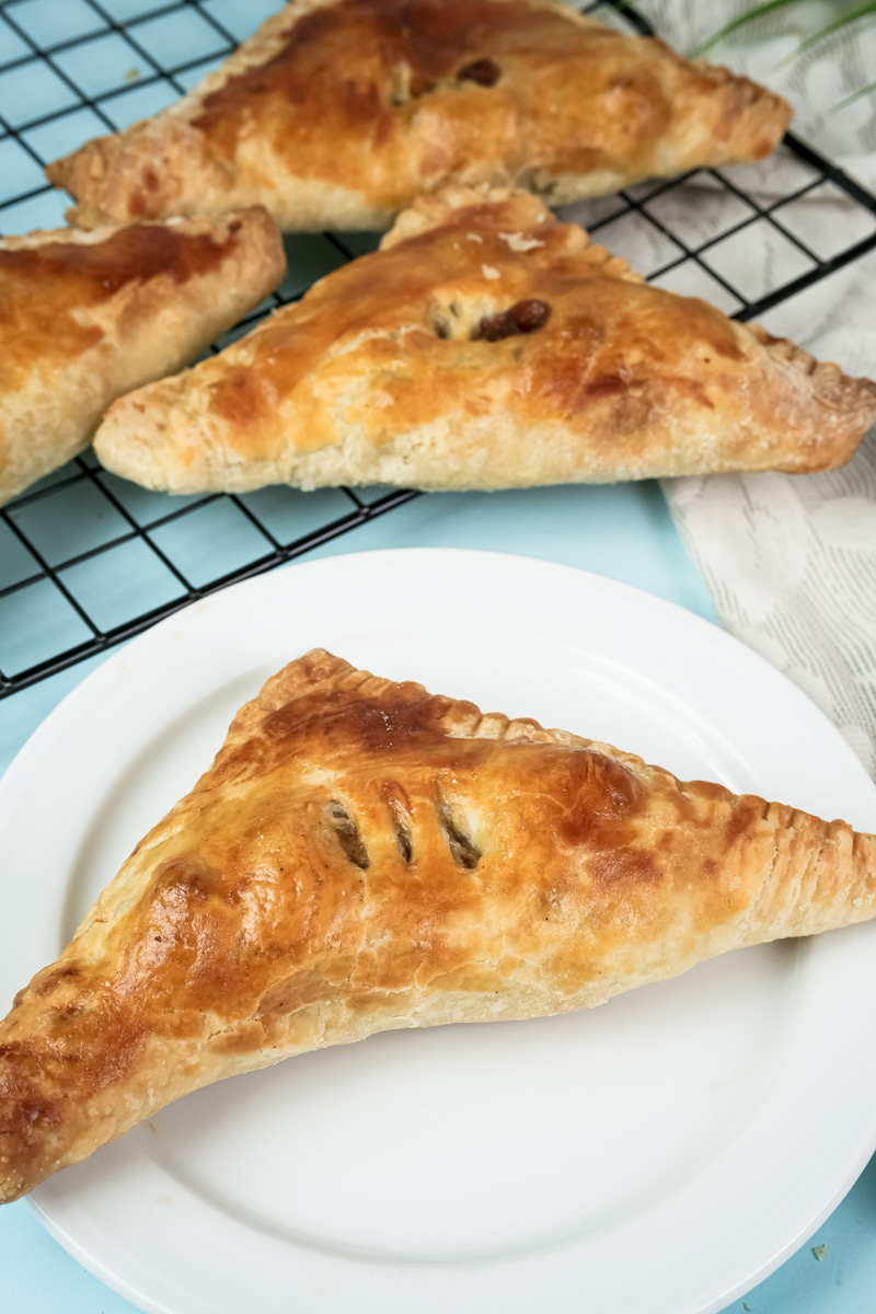 Finished apple turnovers cooling on rack and plated
