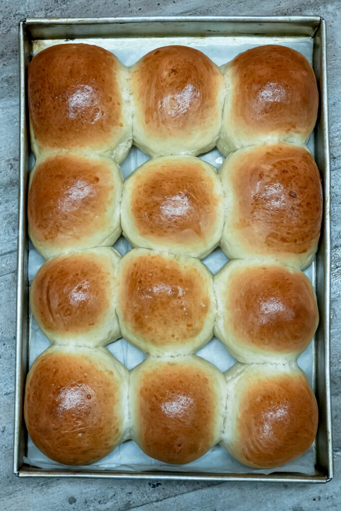 Freshly baked golden Korean buns in baking pan