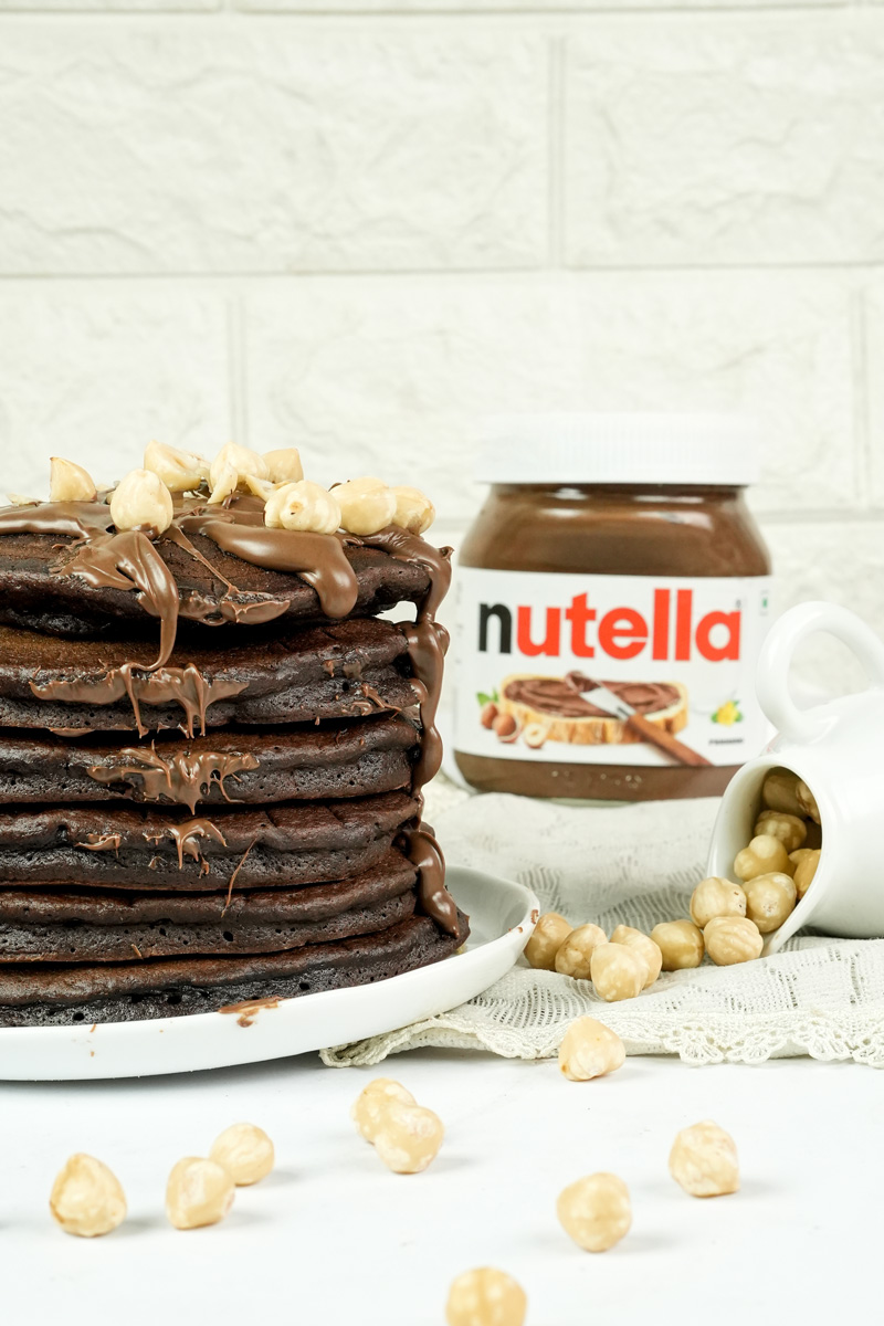 Stack of chocolate Nutella pancakes with hazelnut topping
