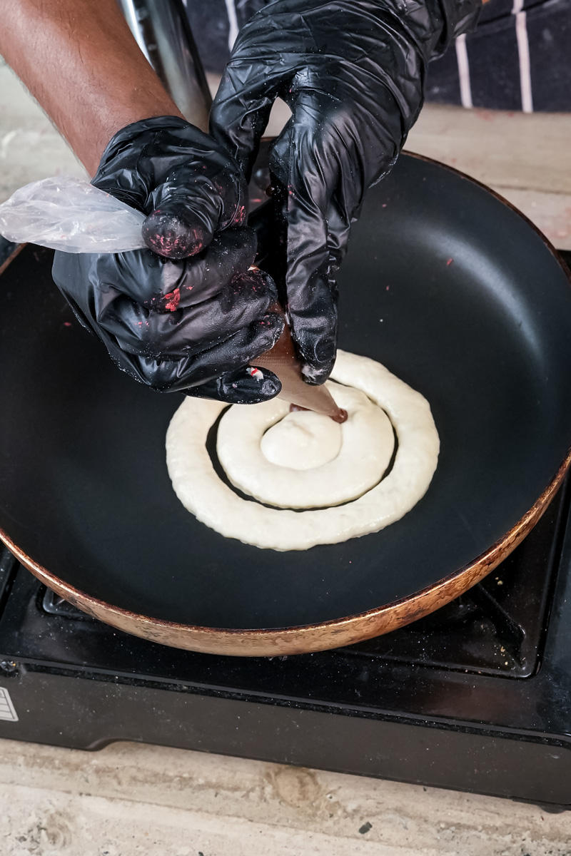 Creating cinnamon swirl pattern on pancake batter in cooking pan