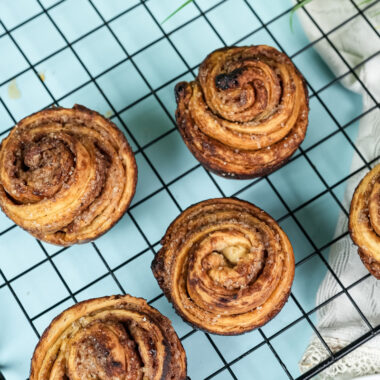 Overhead view of cruffins cooling on wire rack