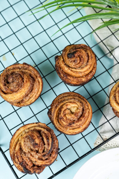 Overhead view of cruffins cooling on wire rack