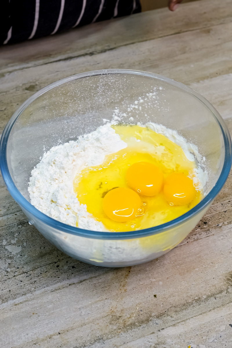 Citrus cake ingredients - flour and eggs in mixing bowl