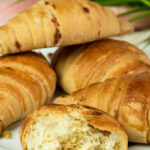 Cross-section of homemade croissant bread revealing airy texture