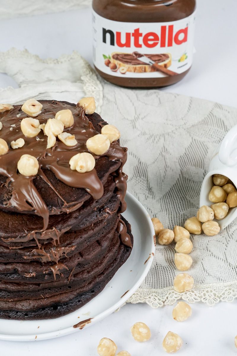 Close-up of layered Nutella pancakes with chocolate sauce