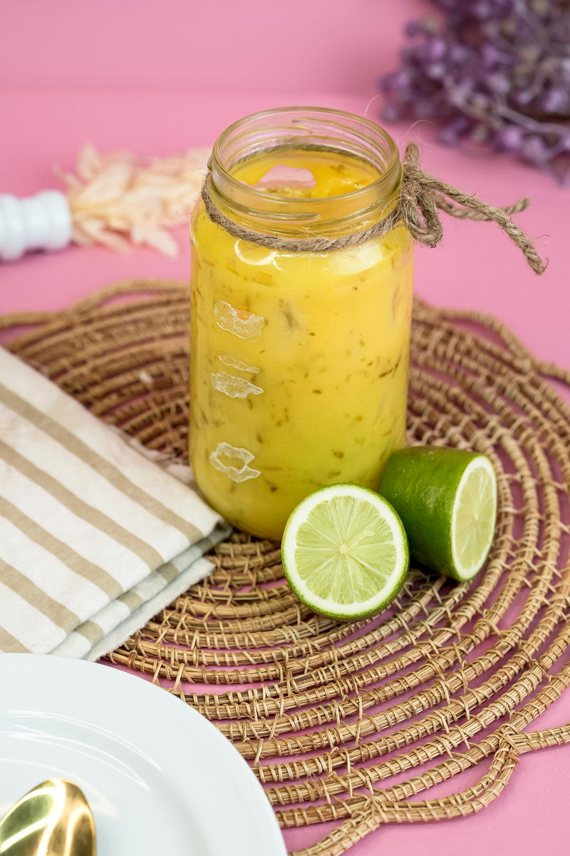 Finished lemon curd in decorative jar with fresh citrus