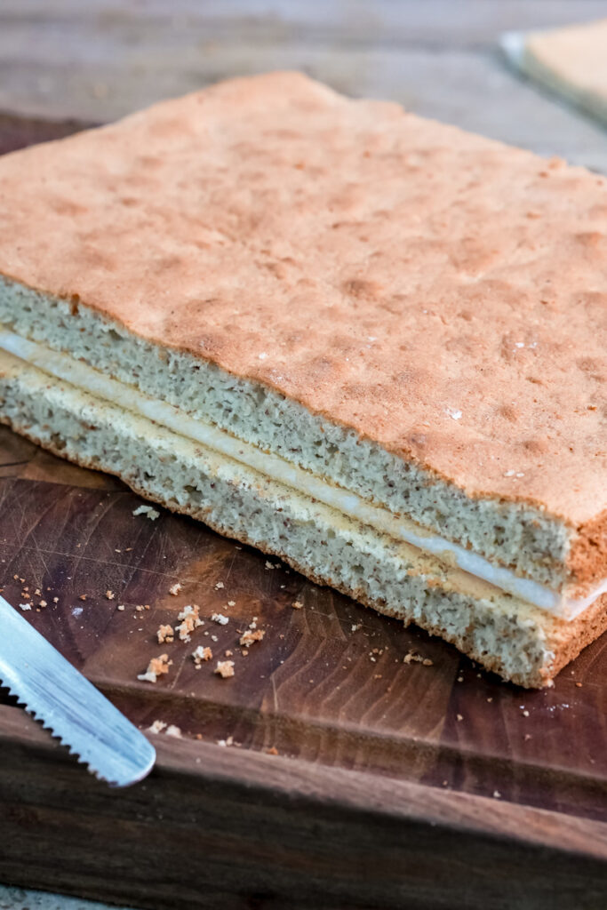 Cross-section view of opera cake showing distinct colored sponge and cream layers