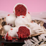 Cross-section of strawberry cake pop showing red interior and white coating