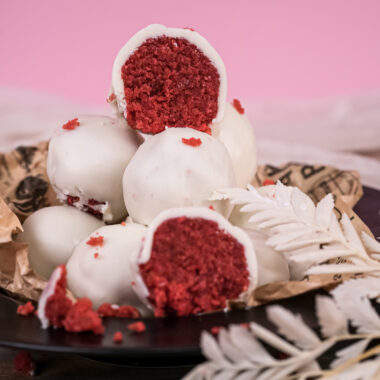 Cross-section of strawberry cake pop showing red interior and white coating
